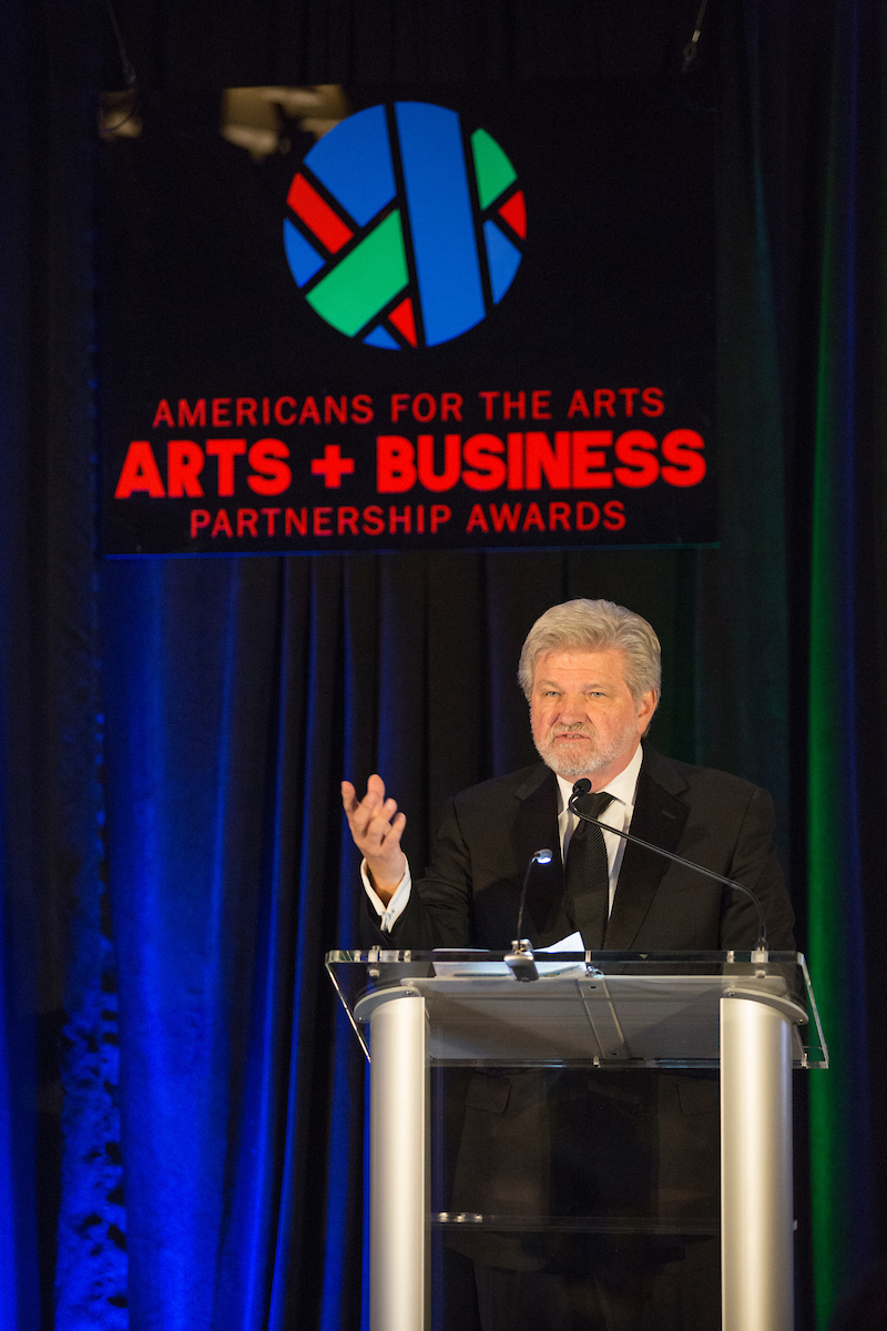 Americans for the Arts President and CEO Robert Lynch speaks at a podium