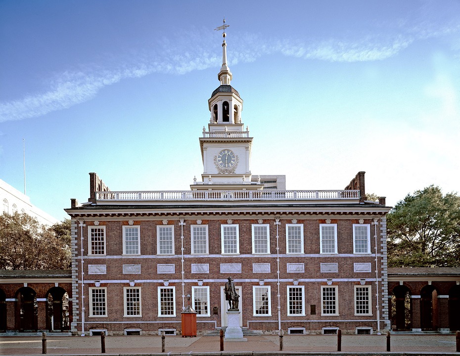 Independence Hall, a historic brick building with a cupola and windvane